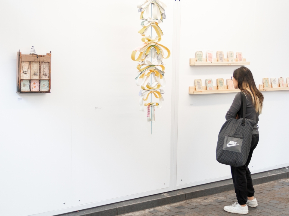 A visitor admiring an artwork at artch Festival